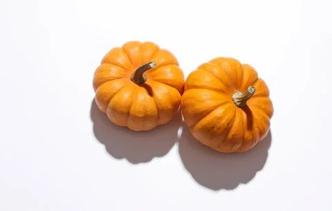 Two small orange pumpkins on a white background Stock Photos