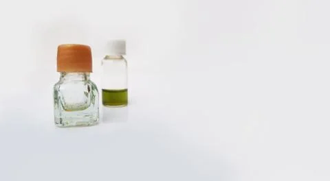 Two small perfume or attar bottles isolated in white background with selectiv Stock Photos