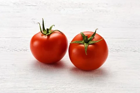 Two small ripe red tomatoes Stock Photos