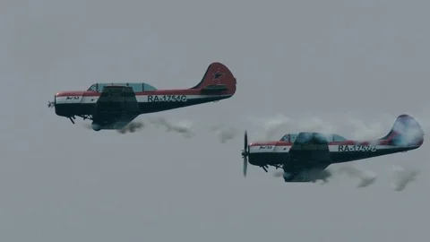 Two small single engine airplanes flying against clear blue skies Stock-Footage 69932447