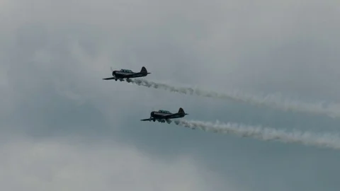 Two small single engine airplanes doing stunts Stock Footage 69934134