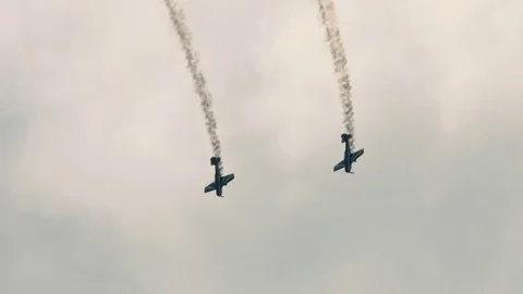 Two small single engine airplanes doing stunts Stock Footage 69934144