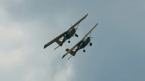 Two small single engine airplanes doing stunts Stock Footage 69934249