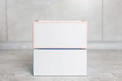 Two small white cardboard boxes on a grey background. Place for your text Stock Photos
