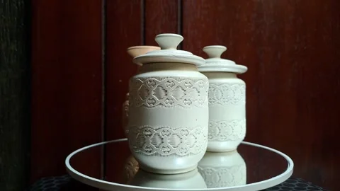 Two small white ceramic pieces resembling lidded cylinders Stock Footage 341306834