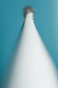 Two small white snail shells on a white post Stock Photos