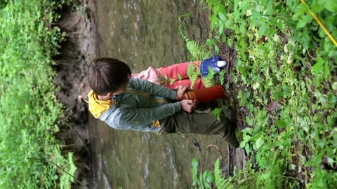 Two smaller children, filtering drinking water with filter bottles Stock Footage 310542775