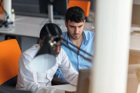 Two smart businessman using smartphone and laptop workig in office. Stock Photos
