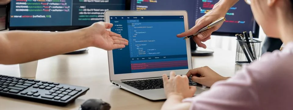 Two smart computer engineers working together to solve program code. Burgeoning. Photos