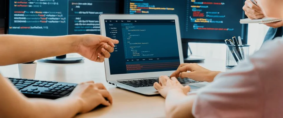 Two smart computer engineers working together to solve program code. Burgeoning. 스톡 사진