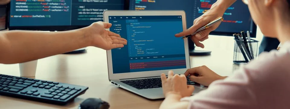 Two smart computer engineers working together to solve program code. Burgeoning. Stock-Fotos