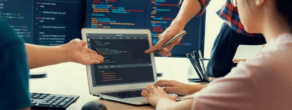 Two smart computer engineers working together to solve program code. Burgeoning. Photos