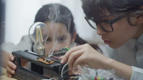 Two smart kids practicing their hobby in electrical engineering Video stock 231748843