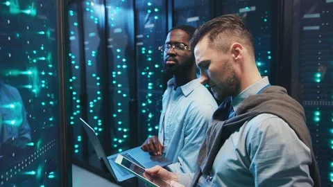 Two smart men IT specialists coworking in server room running maintenance backup Video stock 120482538