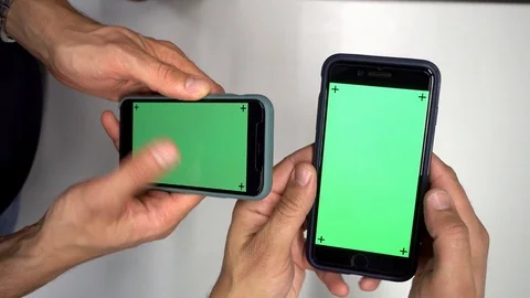 Two smart phones manipulating by persons at office, green screen 1080 format Stock-Footage 126012233