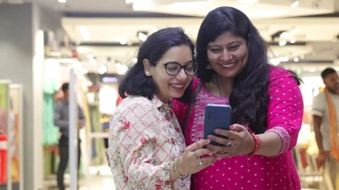 Two smart women using mobile phone advanced technology standing. Stock Footage 245296481