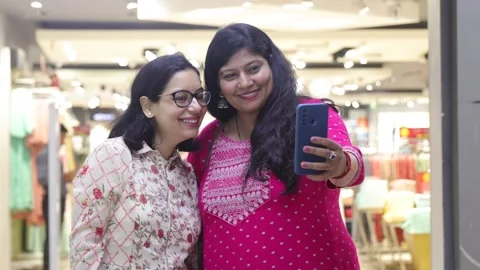 Two smart women using mobile phone advanced technology standing. Stock Footage 245296500