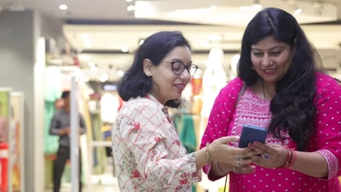 Two smart women using mobile phone advanced technology standing. Stock Footage 245296512