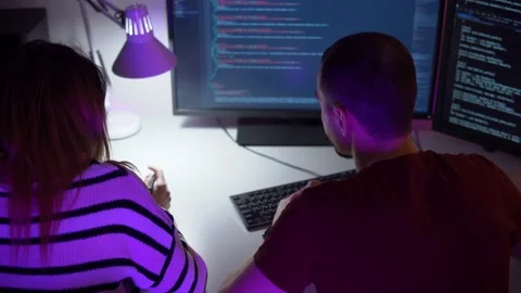Two smart young programmers are coding on computer in process of discussion Stock Footage 151719335