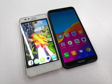 Two smartphones with Android operating system from Huawei and Honor. Stock Photos