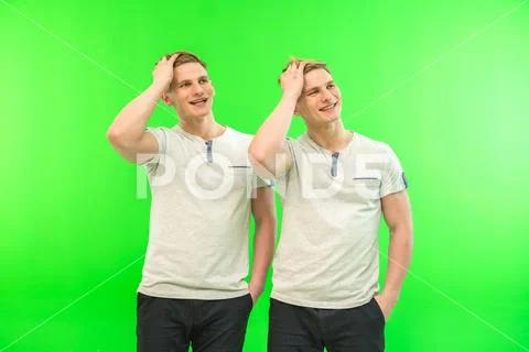 The two smile twin brother gesture on the green background Stock Photos