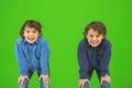 The two smile twin kids gesture on the green background Photo