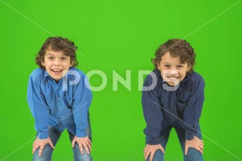 The two smile twin kids gesture on the green background Stock Photos