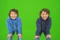 The two smile twin kids gesture on the green background Photo