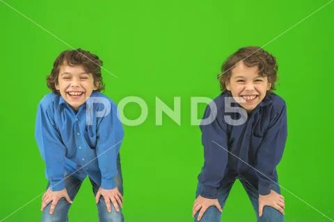 The two smile twin kids gesture on the green background Stock Photos