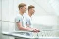 The two smile twin stand on the office balcony Photo