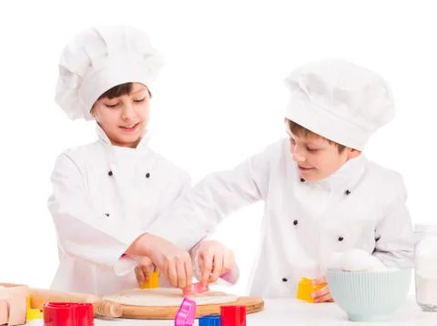 Two smiling children in the kitchen Foto stock