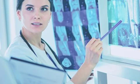 Two smiling doctors pointing at x-rays in a hospital consulting room Stock Photos