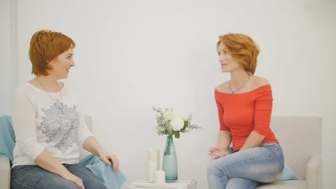 Two smiling friends talking to each other in the living room Stock Footage 74477437