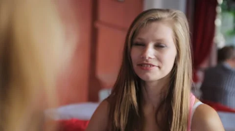 Two smiling girlfriends talking Stock Footage 63529999