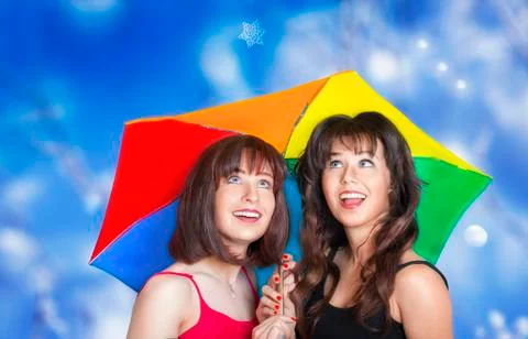 Two smiling girls looking at the snowflake falling Stock Photos
