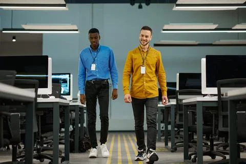Two smiling male managers in IT office Stock Photos