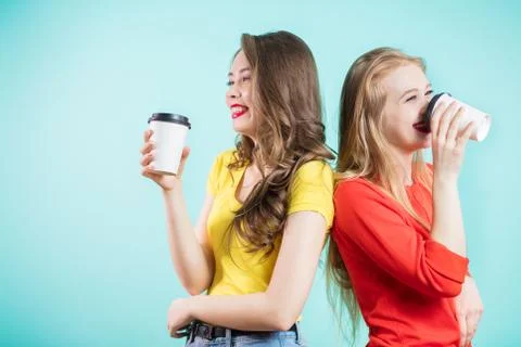 Two smiling students having a cup of coffee. happy young women laugh, back to Stock Photos