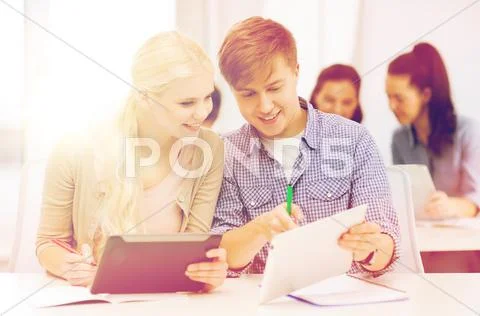 Two smiling students with tablet pc and notebooks Stock Photos
