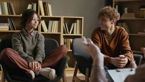 Two Smiling Teens Holding Hands in Couple Therapy after Conflict Resolution Video stock 326684502