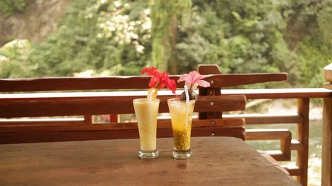 Two smoothie cocktails on a table Stock Footage 107635279