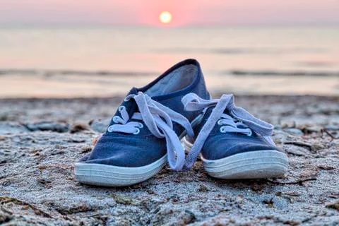 Two sneakers at the beach Stock Photos