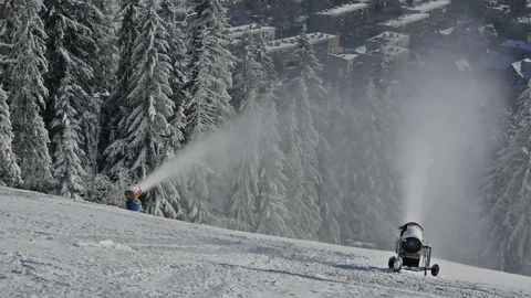 Two snow making machines on a skying slope Stock Footage 80197579