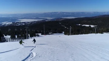 Two snowboarders riding down an empty slope Stock Footage 86109815