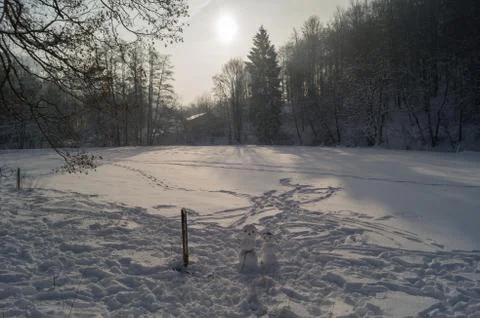 Two snowman on a field Stock Photos