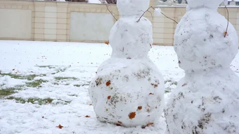 Two snowmans in the snowy yard on winter Stock Footage 144867340