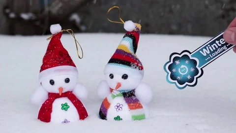 Two snowmen and winter loading symbol Stock Footage 70488661