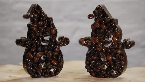 Two Snowmen Made of Coffee Beans on Light Background Stock Photos