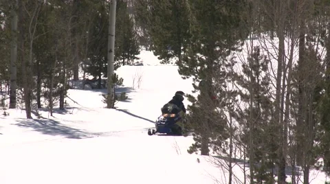 Two snowmobiles pass through frame- two shots Stock Footage 41636291