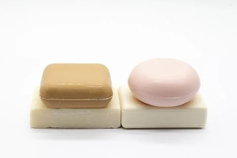 Two soaps rest neatly on a plain white surface Stock Photos