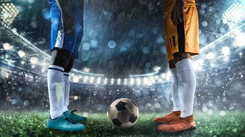 Two soccer players challenge each other at the stadium Stock Photos